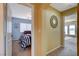 Hallway with tan walls offering views into bedrooms featuring unique mirrors and decor at 1883 Nature Park Dr, North Las Vegas, NV 89084