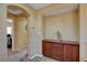 Hallway featuring display cabinet, neutral carpet, archway and view to second bedroom at 1883 Nature Park Dr, North Las Vegas, NV 89084