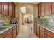 View of the kitchen showcasing granite countertops, tile backsplash, and dark wood cabinetry at 1883 Nature Park Dr, North Las Vegas, NV 89084