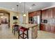 Modern kitchen featuring a granite island with seating and stainless steel appliances at 1883 Nature Park Dr, North Las Vegas, NV 89084