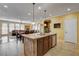 Bright open-concept kitchen featuring an island and seamless transition to the dining and living areas at 1883 Nature Park Dr, North Las Vegas, NV 89084