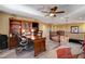 Upstairs living room with ceiling fan, desk, leather seating, and a staircase at 1883 Nature Park Dr, North Las Vegas, NV 89084