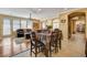 Open-concept dining area with direct view of the cozy living room and natural light from the windows at 1883 Nature Park Dr, North Las Vegas, NV 89084