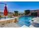 Sparkling swimming pool and jacuzzi with lush landscaping for privacy at 1883 Nature Park Dr, North Las Vegas, NV 89084