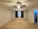 Large bedroom featuring two ceiling fans, carpet flooring, and a connecting bathroom at 2037 Houdini St, Henderson, NV 89002