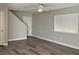 Bright and airy living room with wood-look flooring, a ceiling fan, and natural light at 2037 Houdini St, Henderson, NV 89002