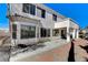 Exterior view of a home featuring a covered patio and multiple windows overlooking the backyard at 21 Bridal Falls Ct, Las Vegas, NV 89148