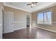 Bedroom with neutral walls, crown molding, wood-like floors, and a sunny window at 21 Bridal Falls Ct, Las Vegas, NV 89148