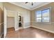 Bedroom with wood floors, closet, and an ensuite bathroom with natural light at 21 Bridal Falls Ct, Las Vegas, NV 89148