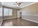 Bedroom featuring neutral colors, crown molding, wood-like floors, and a sunny window at 21 Bridal Falls Ct, Las Vegas, NV 89148