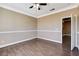 Bedroom featuring neutral colors, crown molding, wood-like floors, and two entry ways at 21 Bridal Falls Ct, Las Vegas, NV 89148