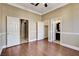 Bedroom with wood floors and multiple doorways to adjacent rooms and bathroom at 21 Bridal Falls Ct, Las Vegas, NV 89148