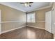 Bedroom with neutral colors, crown molding, wood-like floors, and a single window at 21 Bridal Falls Ct, Las Vegas, NV 89148