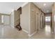 Hallway view with staircase and multiple entryways with neutral color palette at 21 Bridal Falls Ct, Las Vegas, NV 89148