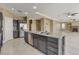 Open kitchen with stainless steel appliances and a large island, flowing into the living area at 21 Bridal Falls Ct, Las Vegas, NV 89148