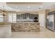 Kitchen showcasing an island with a stone base, stainless steel appliances, and ample cabinet space at 21 Bridal Falls Ct, Las Vegas, NV 89148