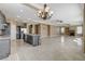 View of kitchen with island and sink overlooking large living room and fireplace at 21 Bridal Falls Ct, Las Vegas, NV 89148