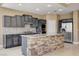 Bright kitchen with gray cabinetry, stone-clad island, and stainless steel appliances at 21 Bridal Falls Ct, Las Vegas, NV 89148