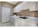 Functional laundry room featuring modern appliances, ample counter space, and white cabinets at 21 Bridal Falls Ct, Las Vegas, NV 89148