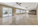 Bright living room with sliding doors leading to outdoor area and a view of the kitchen at 21 Bridal Falls Ct, Las Vegas, NV 89148