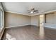 Open living room with wood floors, ceiling fan, and view into the bathroom at 21 Bridal Falls Ct, Las Vegas, NV 89148