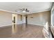 Bright living room features wood floors, ceiling fan and access to other rooms at 21 Bridal Falls Ct, Las Vegas, NV 89148