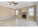 Spacious living room with stone fireplace, tile floors, and natural light at 21 Bridal Falls Ct, Las Vegas, NV 89148