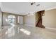 Bright living room with tile flooring, staircase, and large windows at 21 Bridal Falls Ct, Las Vegas, NV 89148