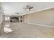 Open living room with tile flooring connecting to the kitchen and dining area at 21 Bridal Falls Ct, Las Vegas, NV 89148