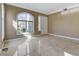 Bright living room with tile floors and large window looking out onto the front yard at 21 Bridal Falls Ct, Las Vegas, NV 89148