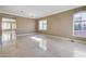 Open living room area with travertine tile flooring and natural light at 21 Bridal Falls Ct, Las Vegas, NV 89148