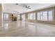 Expansive living room featuring fireplace, tile flooring, and sliding glass doors at 21 Bridal Falls Ct, Las Vegas, NV 89148