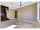 Open living room space with dark wood staircase and tile flooring at 21 Bridal Falls Ct, Las Vegas, NV 89148