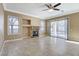 Open living room featuring tile flooring, fireplace, and sliding glass door to the back patio at 21 Bridal Falls Ct, Las Vegas, NV 89148