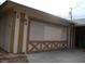 View of the 2-car garage with a door featuring unique criss-cross panel detailing at 224 S Wallace Dr, Las Vegas, NV 89107