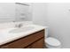 Bathroom with wooden vanity, quartz countertop and modern toilet at 2300 Trasimeno Pl, Henderson, NV 89044