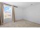 Bright bedroom featuring a large window with neutral curtains and plush carpeting at 2300 Trasimeno Pl, Henderson, NV 89044