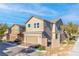 A two-story home with a two-car garage and desert landscaping at 2300 Trasimeno Pl, Henderson, NV 89044