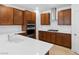 Kitchen with stainless steel appliances, spacious white quartz countertops, and warm brown cabinets at 2300 Trasimeno Pl, Henderson, NV 89044