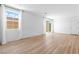 Bright, airy living room featuring wood floors, a large window, and sliding glass door at 2300 Trasimeno Pl, Henderson, NV 89044