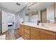 Bathroom featuring a large vanity with double mirrors and warm wood-look floors at 262 Calvino Ave, Las Vegas, NV 89183