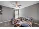 View of a bedroom with two twin beds, ceiling fan, and neutral gray walls at 262 Calvino Ave, Las Vegas, NV 89183