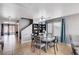 Dining area with a view of the staircase and backyard access and contemporary furnishings at 262 Calvino Ave, Las Vegas, NV 89183