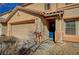 Exterior view of house featuring a blue door and neutral stucco at 262 Calvino Ave, Las Vegas, NV 89183