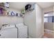 Convenient laundry room featuring a modern washer and dryer with shelving for storage at 262 Calvino Ave, Las Vegas, NV 89183