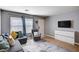 Cozy living room featuring a comfortable gray sofa, flat screen TV and stylish decor at 262 Calvino Ave, Las Vegas, NV 89183