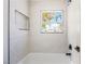 Bright bathroom with a stylish bathtub and a window providing natural light and suburban views at 2632 Cathedral Ln, Las Vegas, NV 89108