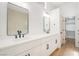 Modern bathroom featuring double sinks, sleek hardware, and a door leading to a spacious walk-in closet at 2632 Cathedral Ln, Las Vegas, NV 89108