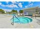 Community hot tub features clear water, blue tiling, and lounge chairs in the background at 2632 Cathedral Ln, Las Vegas, NV 89108