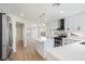 Open-concept kitchen with white cabinets, a kitchen island, and modern lighting fixtures at 2632 Cathedral Ln, Las Vegas, NV 89108